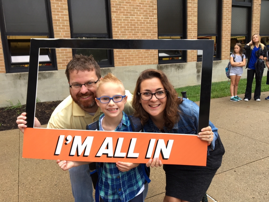 people holding a frame sign